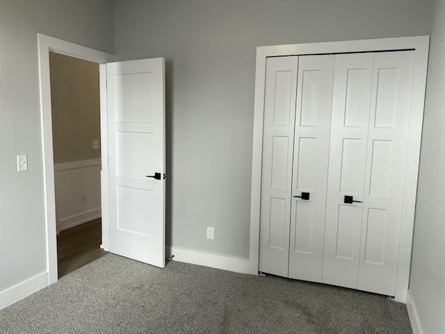 unfurnished bedroom with carpet, baseboards, and a closet