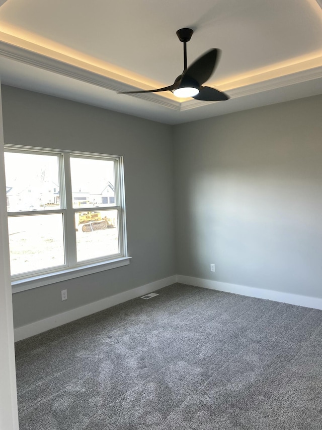 spare room featuring ceiling fan, carpet flooring, and baseboards