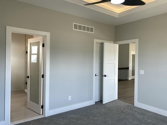 unfurnished bedroom featuring carpet, baseboards, and ornamental molding