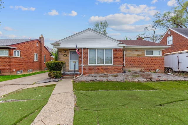 bungalow-style home featuring a front lawn and brick siding