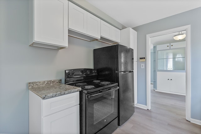 kitchen featuring black appliances, white cabinetry, light wood finished floors, light countertops, and baseboards