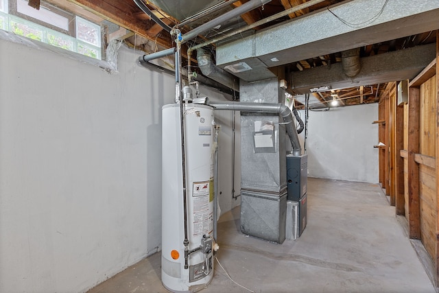 below grade area featuring water heater and heating unit