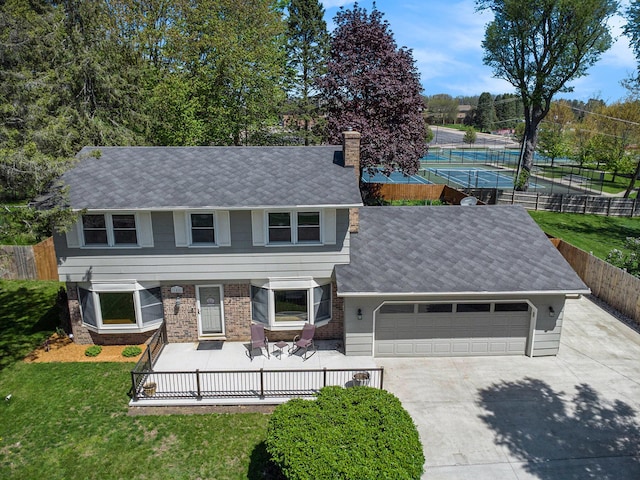 105 N Dr E, Marshall, MI 49068 - view of front facade with driveway, an attached garage, a chimney, and a shingled roof