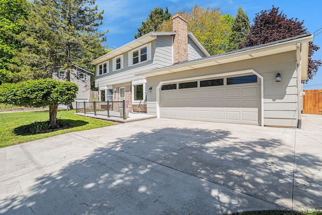 105 N Dr E, Marshall, MI 49068 - view of front of home with driveway, an attached garage, and a chimney