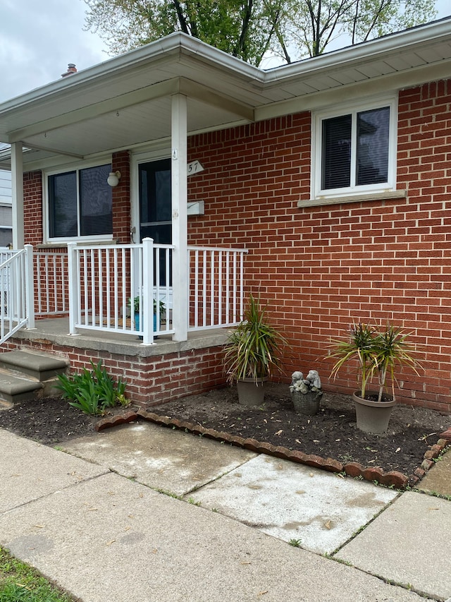 657 Highland Ave, Lincoln Park, MI 48146 - property entrance featuring covered porch and brick siding