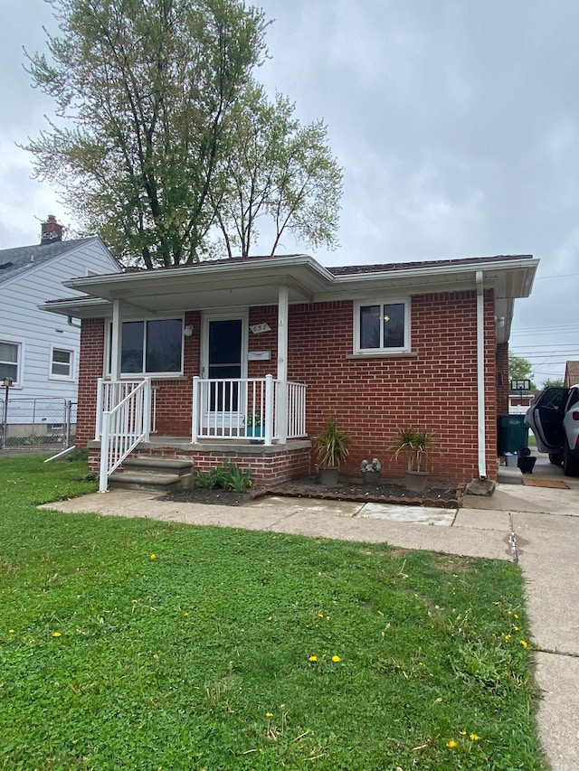 657 Highland Ave, Lincoln Park, MI 48146 - ranch-style house with brick siding and covered porch