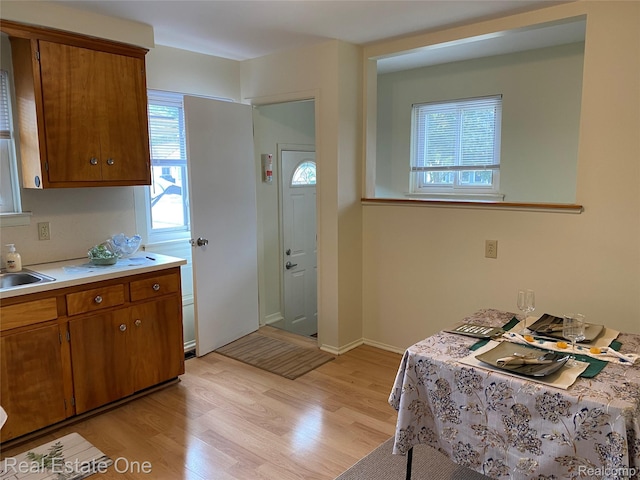 657 Highland Ave, Lincoln Park, MI 48146 - kitchen featuring light wood-type flooring, brown cabinetry, and light countertops