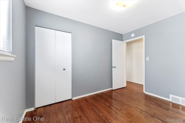 657 Highland Ave, Lincoln Park, MI 48146 - unfurnished bedroom with wood finished floors and a closet