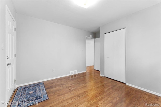 657 Highland Ave, Lincoln Park, MI 48146 - unfurnished bedroom featuring wood finished floors and a closet