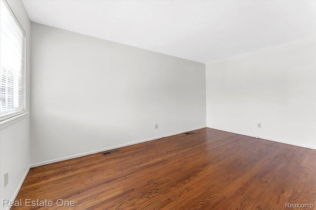 657 Highland Ave, Lincoln Park, MI 48146 - unfurnished room with wood finished floors and baseboards