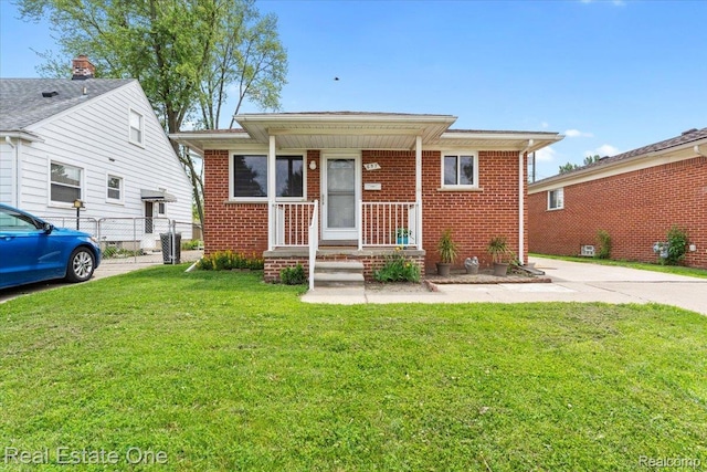 657 Highland Ave, Lincoln Park, MI 48146 - bungalow with brick siding and a porch