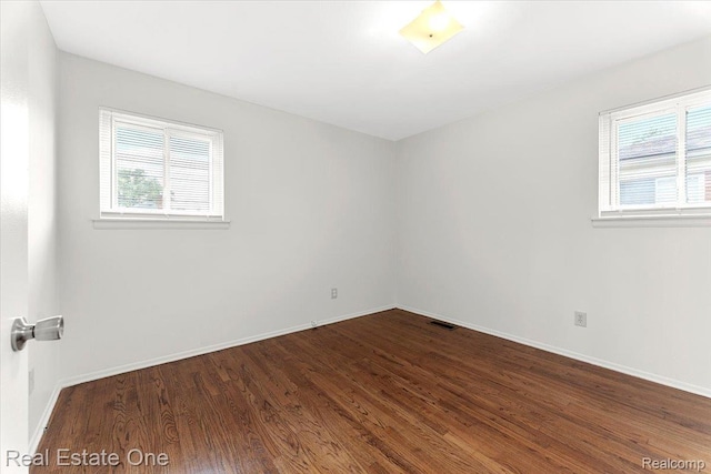 657 Highland Ave, Lincoln Park, MI 48146 - empty room with dark wood-type flooring and baseboards