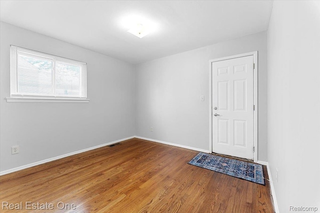 657 Highland Ave, Lincoln Park, MI 48146 - empty room with wood finished floors and baseboards