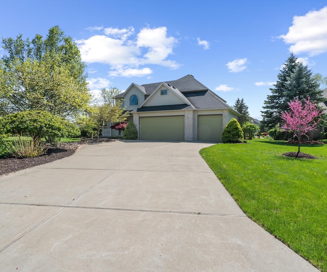 traditional home with concrete driveway, a front yard, and a garage