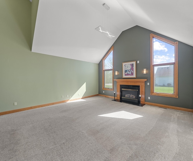 unfurnished living room with lofted ceiling, carpet, a fireplace with flush hearth, and baseboards