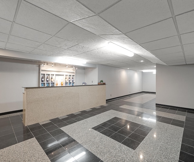 unfurnished room featuring granite floors and baseboards