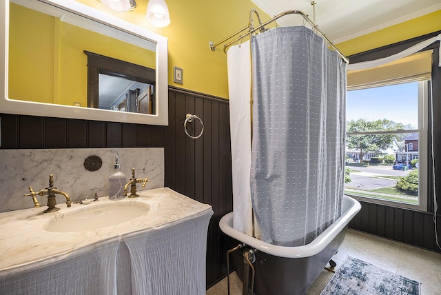 210 E St, Three Rivers, MI 49093 - bathroom with a freestanding tub, ornamental molding, wainscoting, and vanity