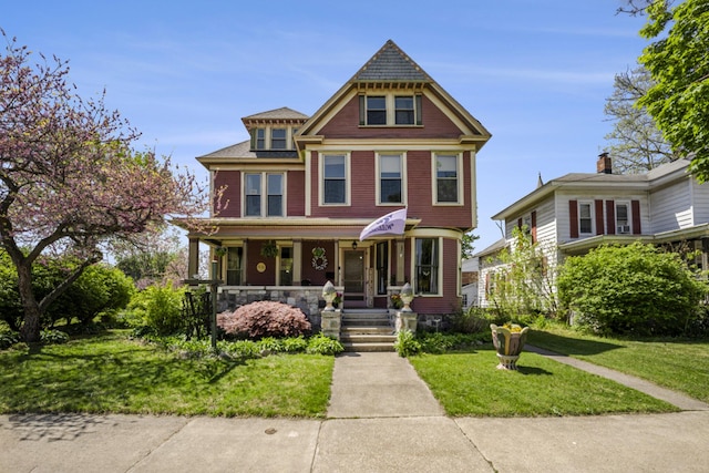 210 E St, Three Rivers, MI 49093 - victorian-style house with covered porch and a front lawn