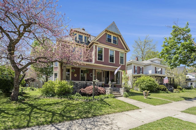 210 E St, Three Rivers, MI 49093 - victorian home with a porch and a front lawn