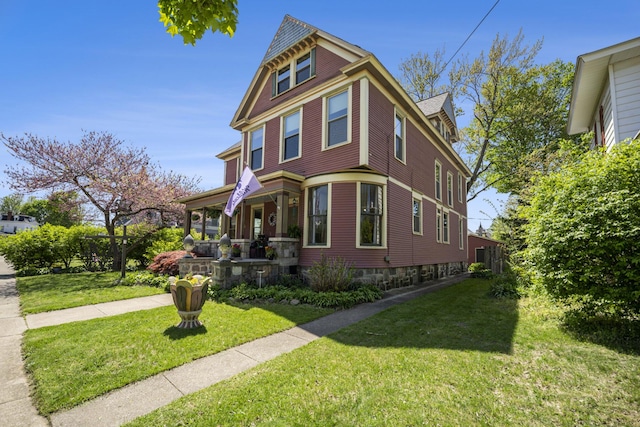 210 E St, Three Rivers, MI 49093 - victorian house with a front lawn and a porch