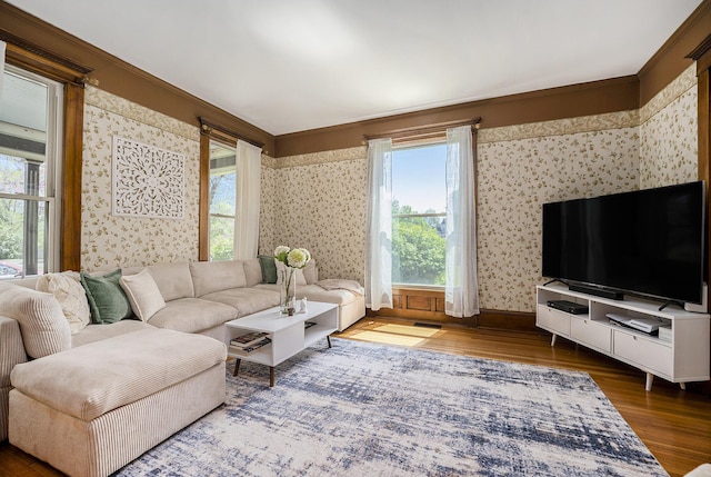 210 E St, Three Rivers, MI 49093 - living area with wood finished floors, wallpapered walls, baseboards, and crown molding