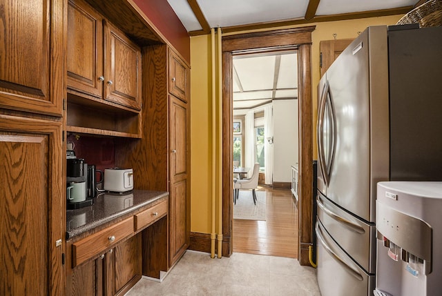 210 E St, Three Rivers, MI 49093 - kitchen with freestanding refrigerator, open shelves, brown cabinets, dark countertops, and light tile patterned floors