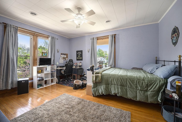 210 E St, Three Rivers, MI 49093 - bedroom featuring multiple windows, crown molding, hardwood / wood-style flooring, a desk, and a ceiling fan