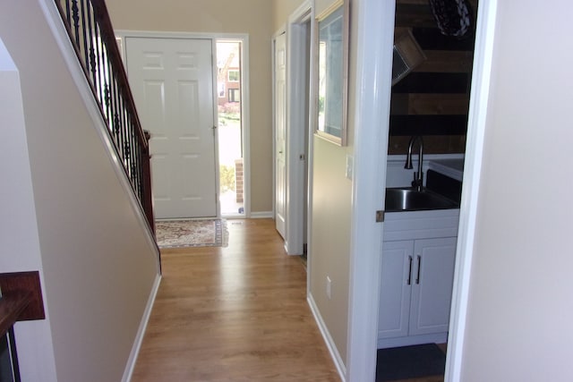 3163 W Ridge Ct, Commerce Twp, MI 48390 - entryway with light wood finished floors, stairs, and baseboards