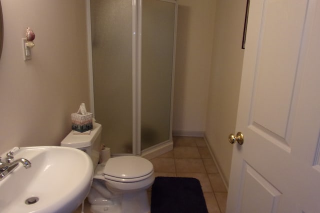 3163 W Ridge Ct, Commerce Twp, MI 48390 - bathroom featuring a sink, a shower stall, toilet, tile patterned flooring, and baseboards