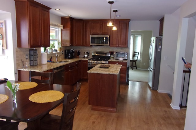 3163 W Ridge Ct, Commerce Twp, MI 48390 - kitchen featuring appliances with stainless steel finishes, a sink, wood finished floors, decorative backsplash, and recessed lighting