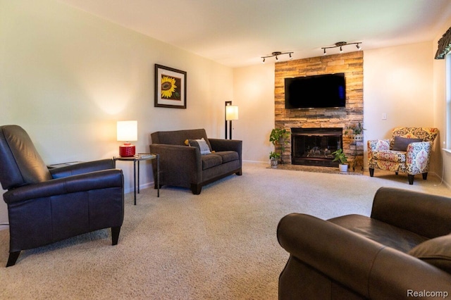 3163 W Ridge Ct, Commerce Twp, MI 48390 - living area with rail lighting, light carpet, and a stone fireplace