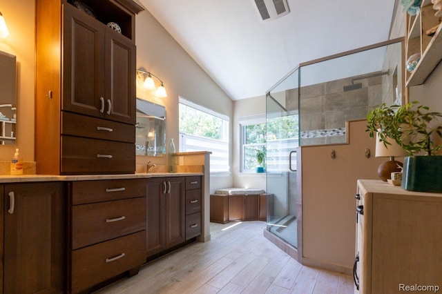 3163 W Ridge Ct, Commerce Twp, MI 48390 - bathroom with lofted ceiling, a shower stall, wood finished floors, vanity, and a garden tub