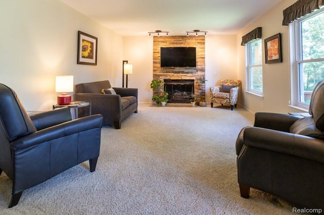 3163 W Ridge Ct, Commerce Twp, MI 48390 - carpeted living area featuring track lighting and a stone fireplace