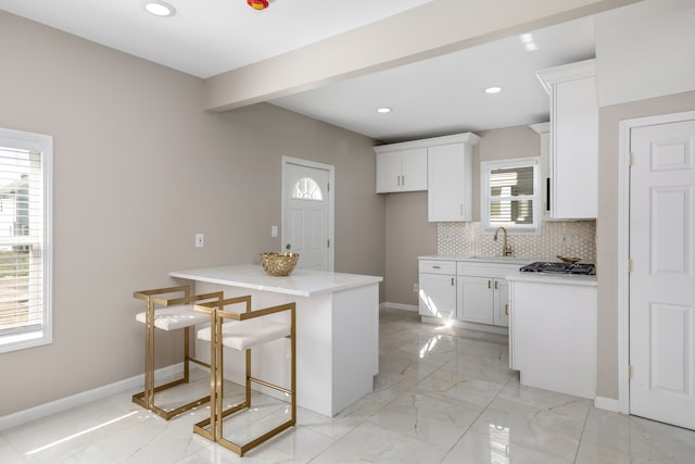 570 King St, Detroit, MI 48202 - kitchen with white cabinets, a sink, light marble finish flooring, baseboards, and recessed lighting