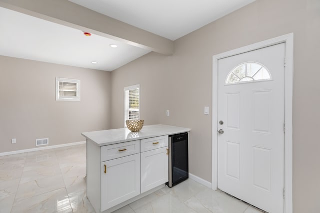 570 King St, Detroit, MI 48202 - kitchen with wine cooler, light marble finish floors, baseboards, light countertops, and recessed lighting