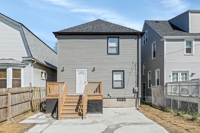 570 King St, Detroit, MI 48202 - rear view of house featuring a deck, fence, and a patio