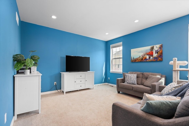 living room featuring light colored carpet, baseboards, and recessed lighting