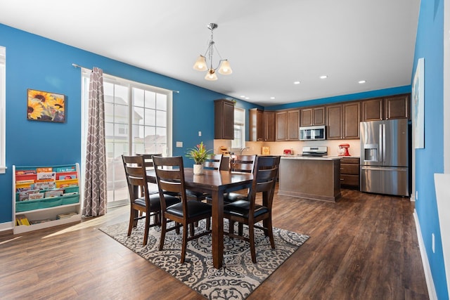 dining room with dark wood-style flooring, recessed lighting, and baseboards