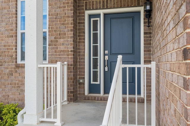 doorway to property with brick siding