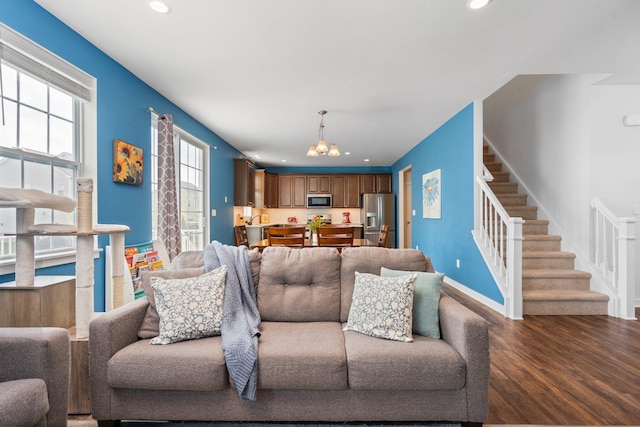 living room featuring a chandelier, stairway, recessed lighting, wood finished floors, and baseboards