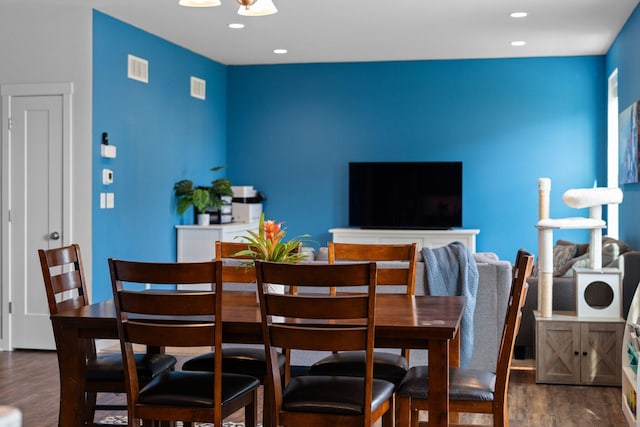 dining area featuring dark wood-type flooring and recessed lighting
