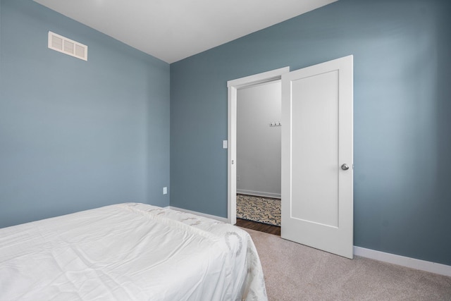 bedroom with carpet flooring and baseboards