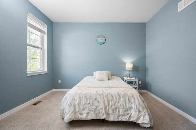 bedroom with carpet floors and baseboards