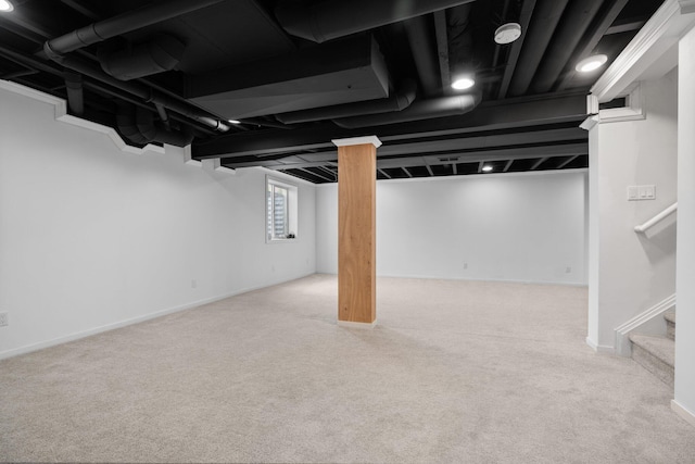 basement with carpet, stairway, and baseboards