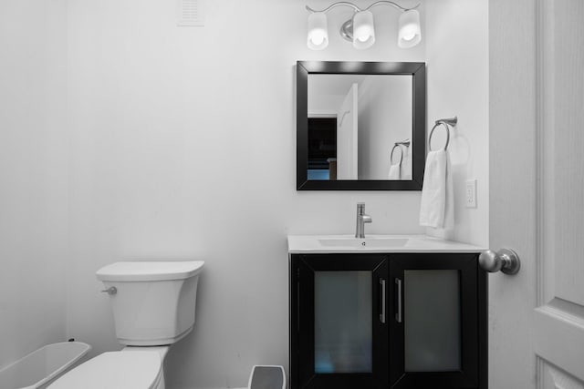 half bath featuring toilet and vanity