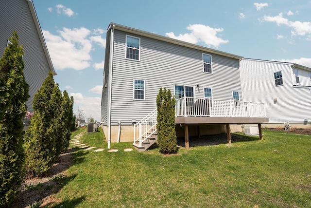 rear view of house with a wooden deck, central air condition unit, a yard, and stairway