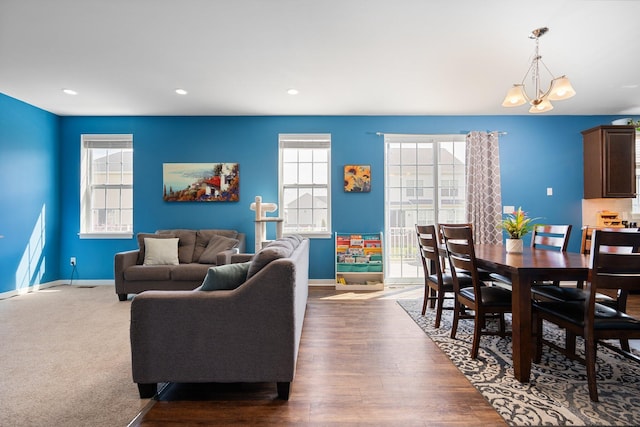 living area with baseboards, a chandelier, recessed lighting, and wood finished floors