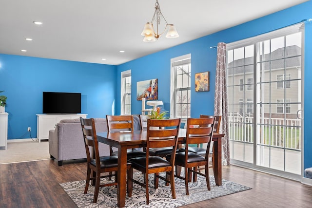 dining room featuring wood finished floors, baseboards, recessed lighting, and a chandelier