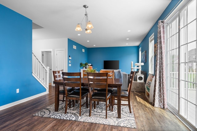 dining space featuring wood finished floors, a chandelier, baseboards, recessed lighting, and stairs
