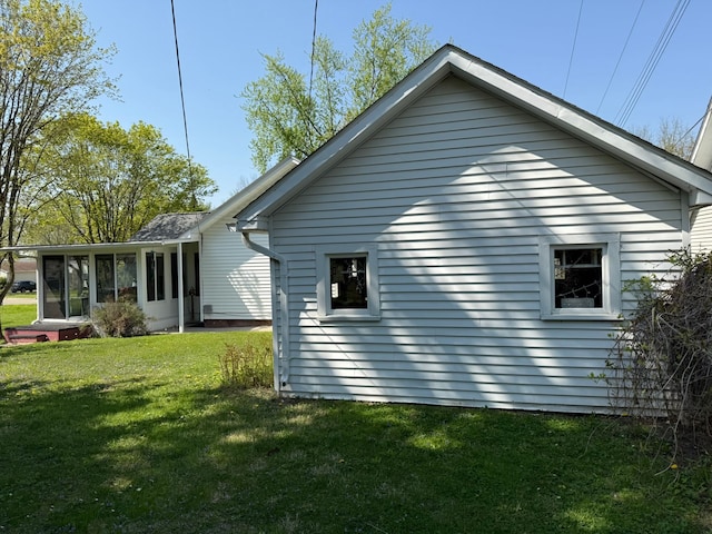 27 Turrill Ave, Lapeer, MI 48446 - view of side of property featuring a lawn and a sunroom